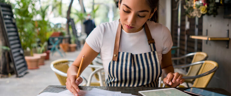 Shop owner working out figures for taxes
