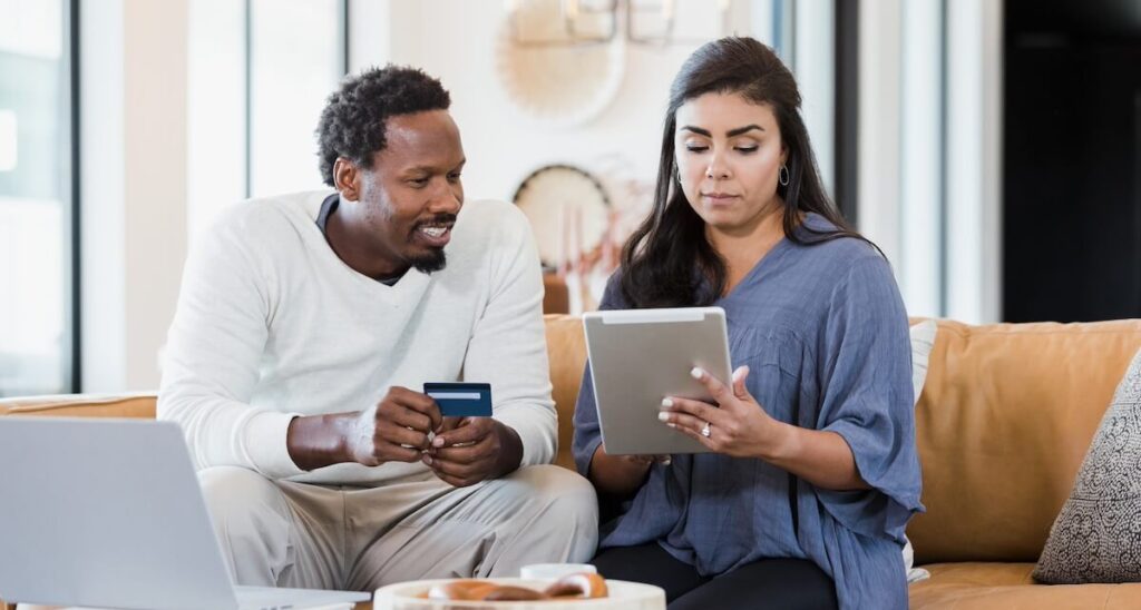 Couple at home transferring their credit card balance